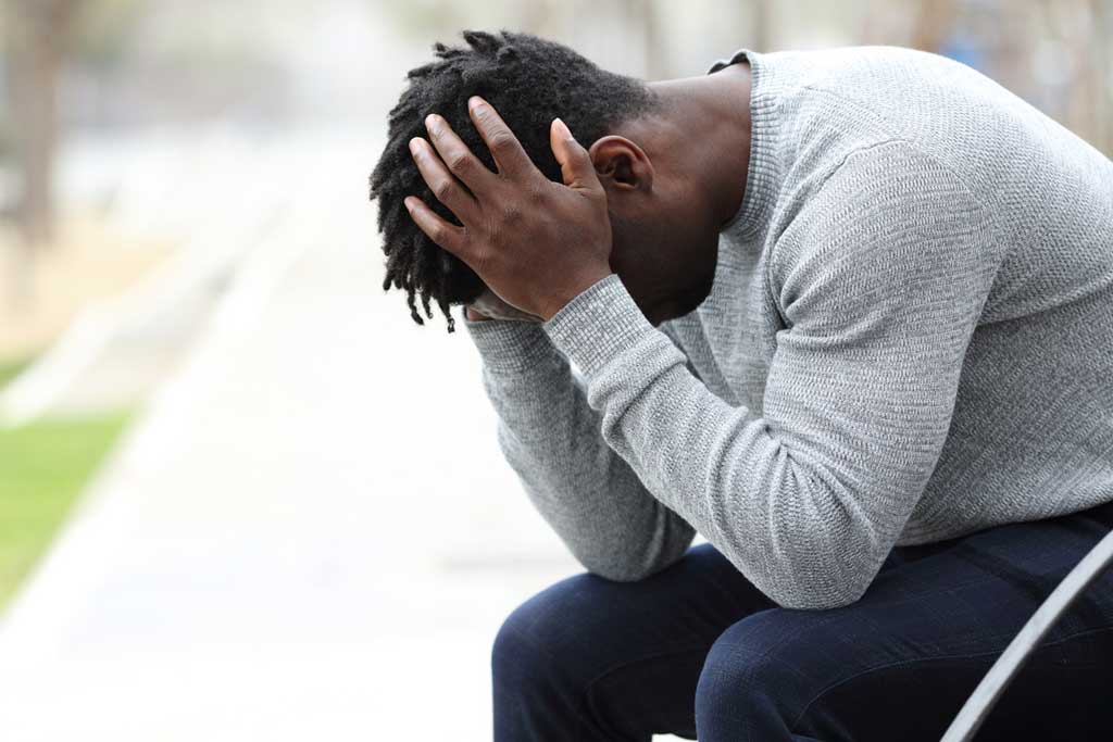 Young African man struggling to cope and dealing with depression