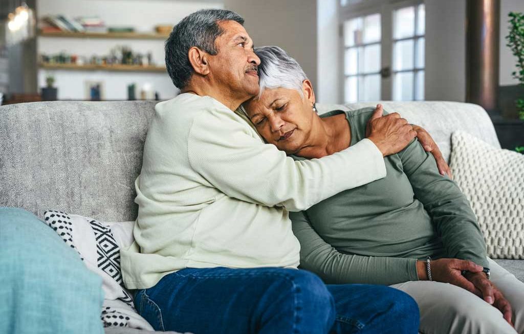 Couple embracing one another after suffering a great loss