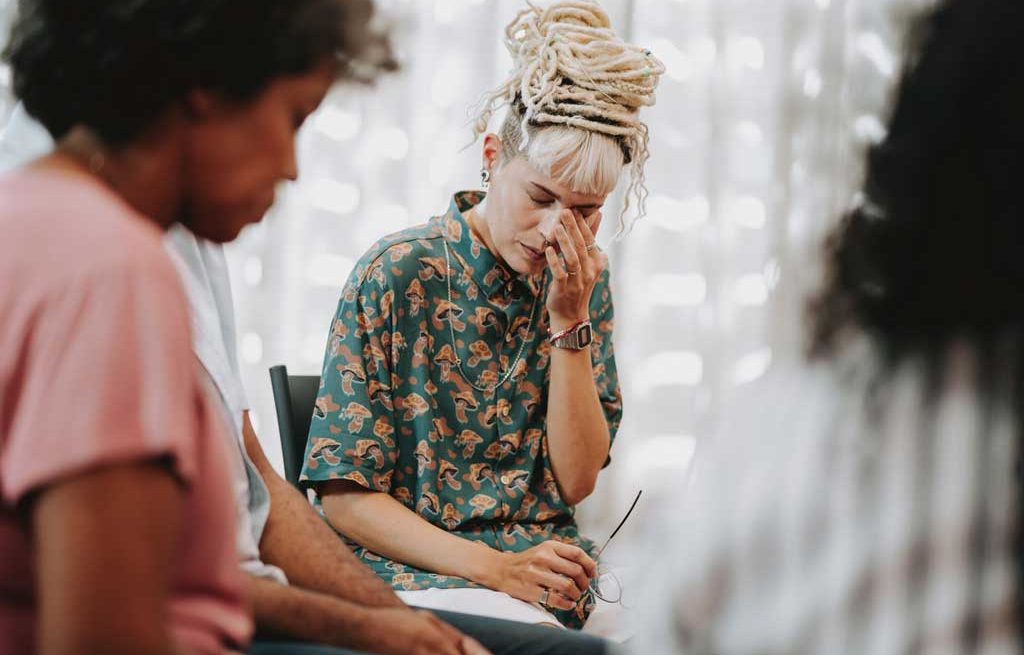 Addition counselling session and emotional woman