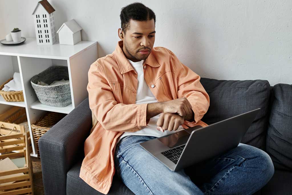 Man Using Sign Language While Working From Home